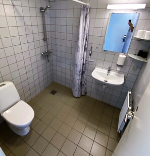 Enjoy a refreshing shower in the walk-in shower with a handheld showerhead and glass door.