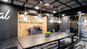 A modern office space with a long conference table, a printer, and a motivational quote on the wall. - Student Factory Bordeaux (Bordeaux)
