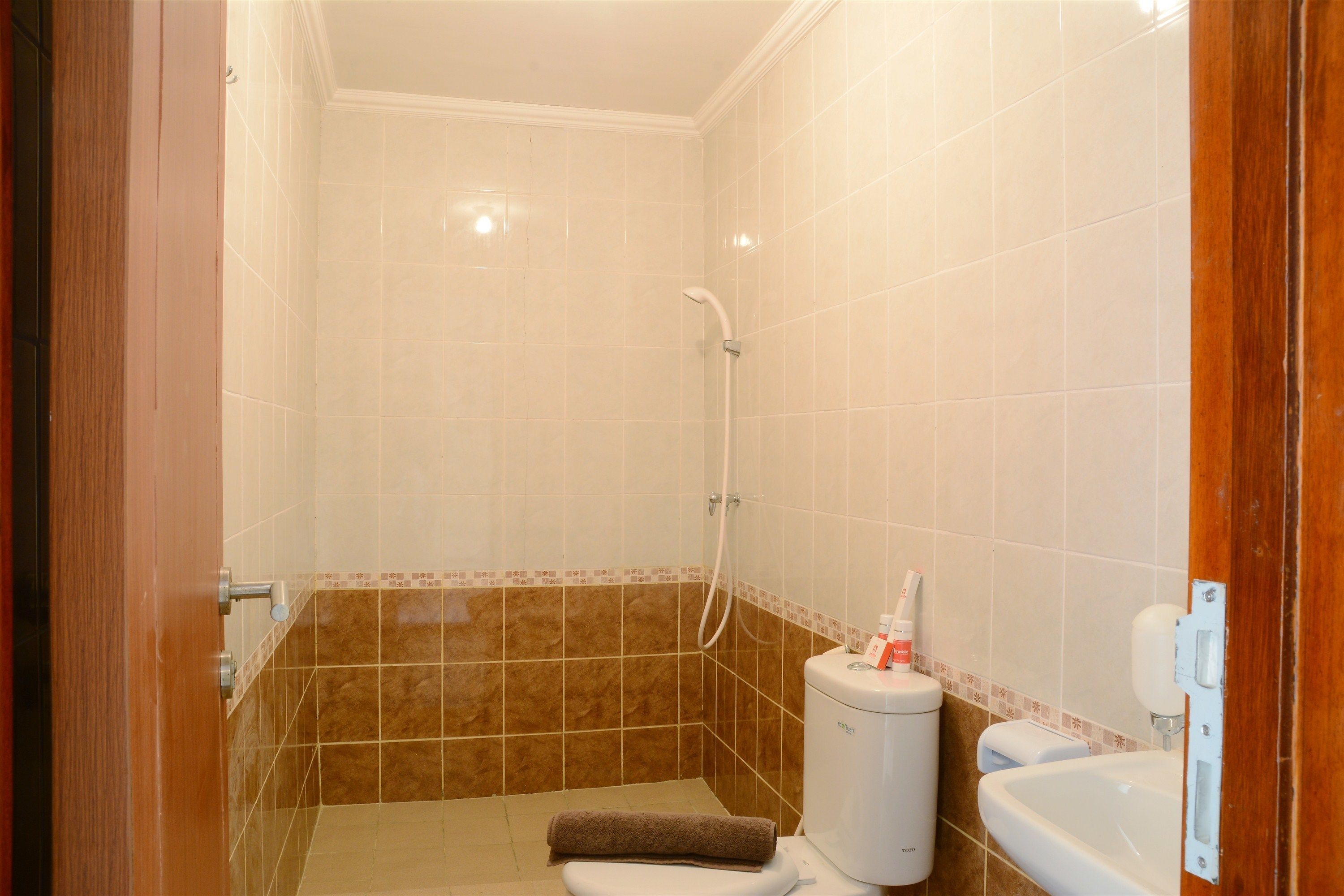 A bathroom with a shower, toilet, and sink.