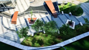 An aerial view of a modern public space with a curved pathway, seating areas, and greenery. - Best North L'Avenue Apartment (Jakarta)