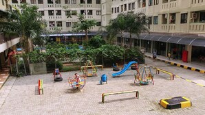 An outdoor playground with various play structures, surrounded by a brick pavement and greenery. - Good Studio 23 Kebagusan City Apartment (Jakarta)
