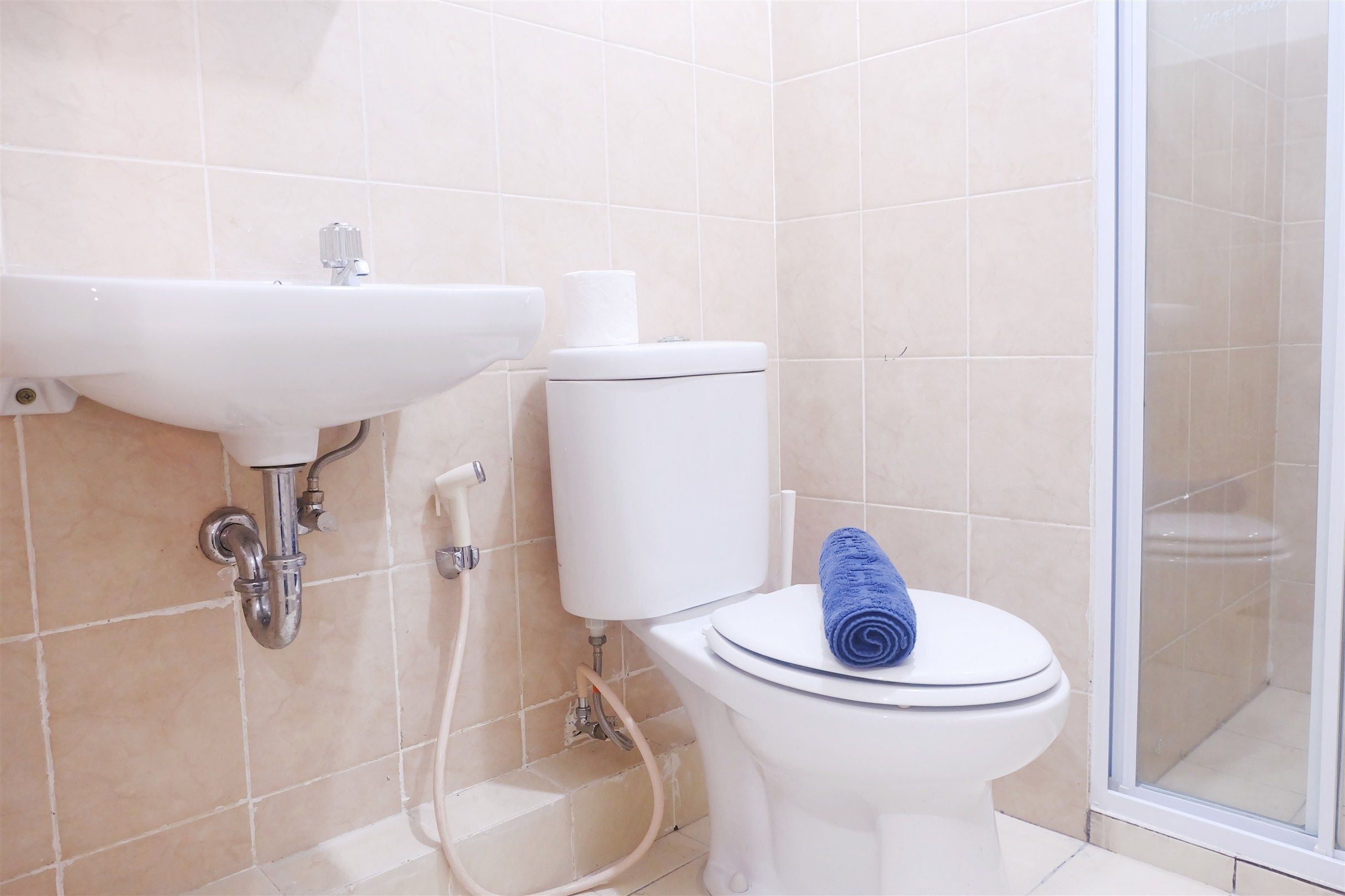 A bathroom with a sink, toilet, and shower.