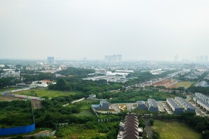 A residential area with multiple apartment buildings, green spaces, and a large industrial complex. - Best Price Brooklyn Apartment near IKEA Alam Sutera (South Tangerang)