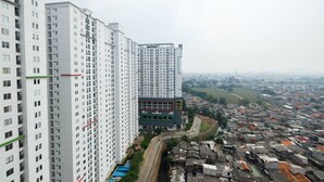 A high-rise building with multiple floors and a ground-level commercial structure.