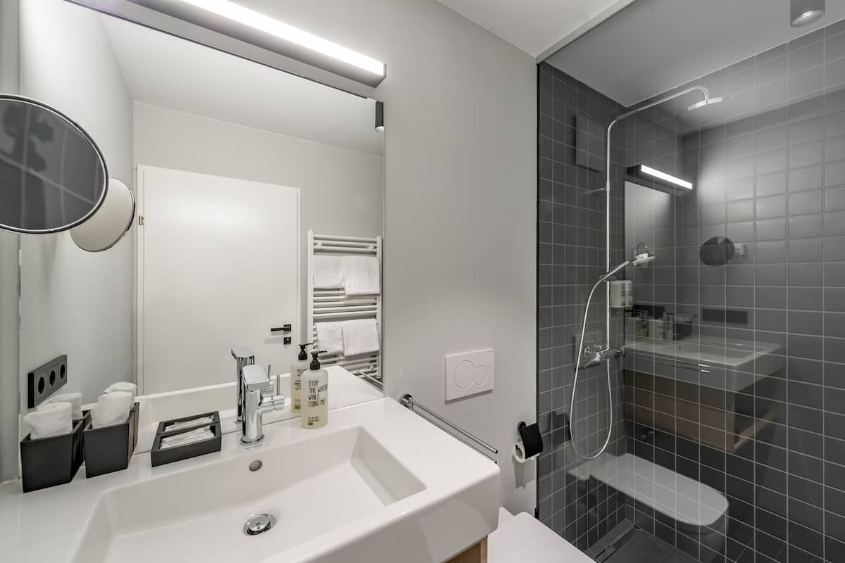 superior double room | bathroom | shower, hair dryer, towels
