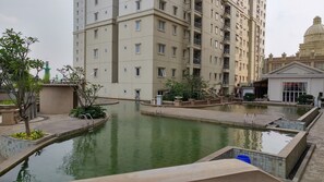A high-rise residential building with multiple balconies and a swimming pool area. - Apartment Palazzo/Grand Palace Kemayoran (Jakarta)