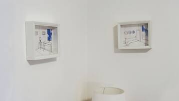 Two wall-mounted light fixtures with simple, modern designs.