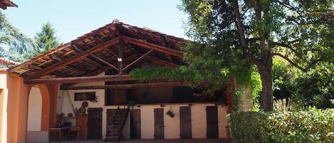 A traditional building with a tiled roof, wooden beams, and a brick wall.