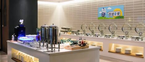 A modern breakfast area with a self-service station, a digital menu display, and a wall-mounted sign.