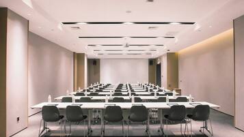 A conference room with tables and chairs, equipped with water bottles and nameplates.