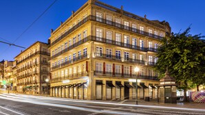 A multi-story hotel with balconies, a covered entrance, and a street view. - One Shot Aliados Goldsmith  (Porto)