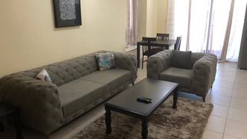 Comfort Apartment, 2 Double Beds, Accessible | Living room | Flat-screen TV