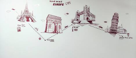 A travel-themed illustration featuring the Eiffel Tower, Arc de Triomphe, Tower Bridge, and Leaning Tower of Pisa, with dates indicating their construction.