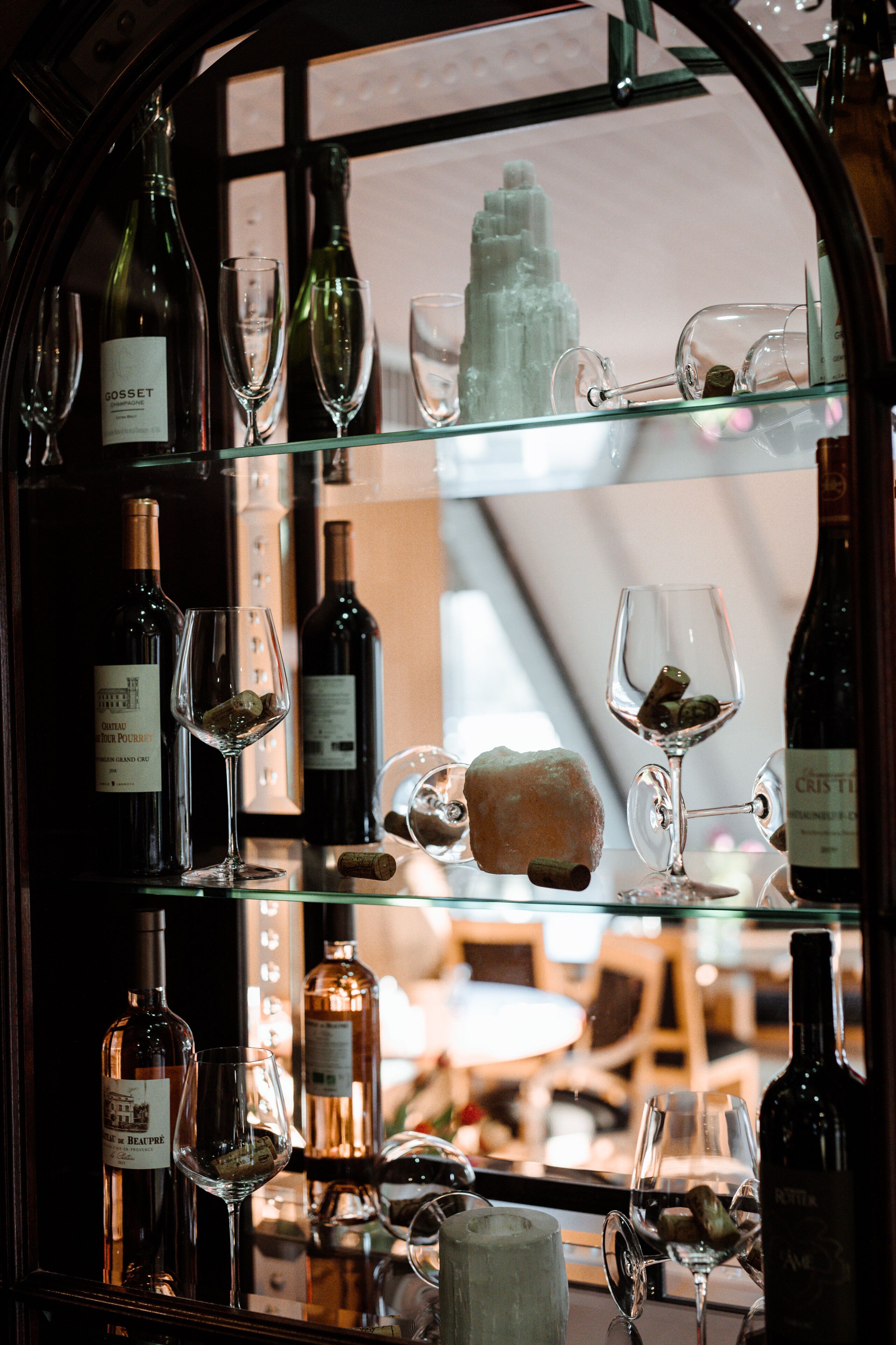 A wine display with bottles and glasses.