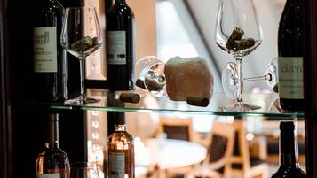 A wine display with bottles and glasses.