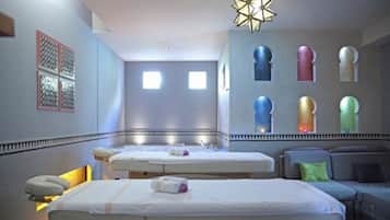 Relax in a stylish room with two single beds, a seating area, and a large window offering a view of the sky.