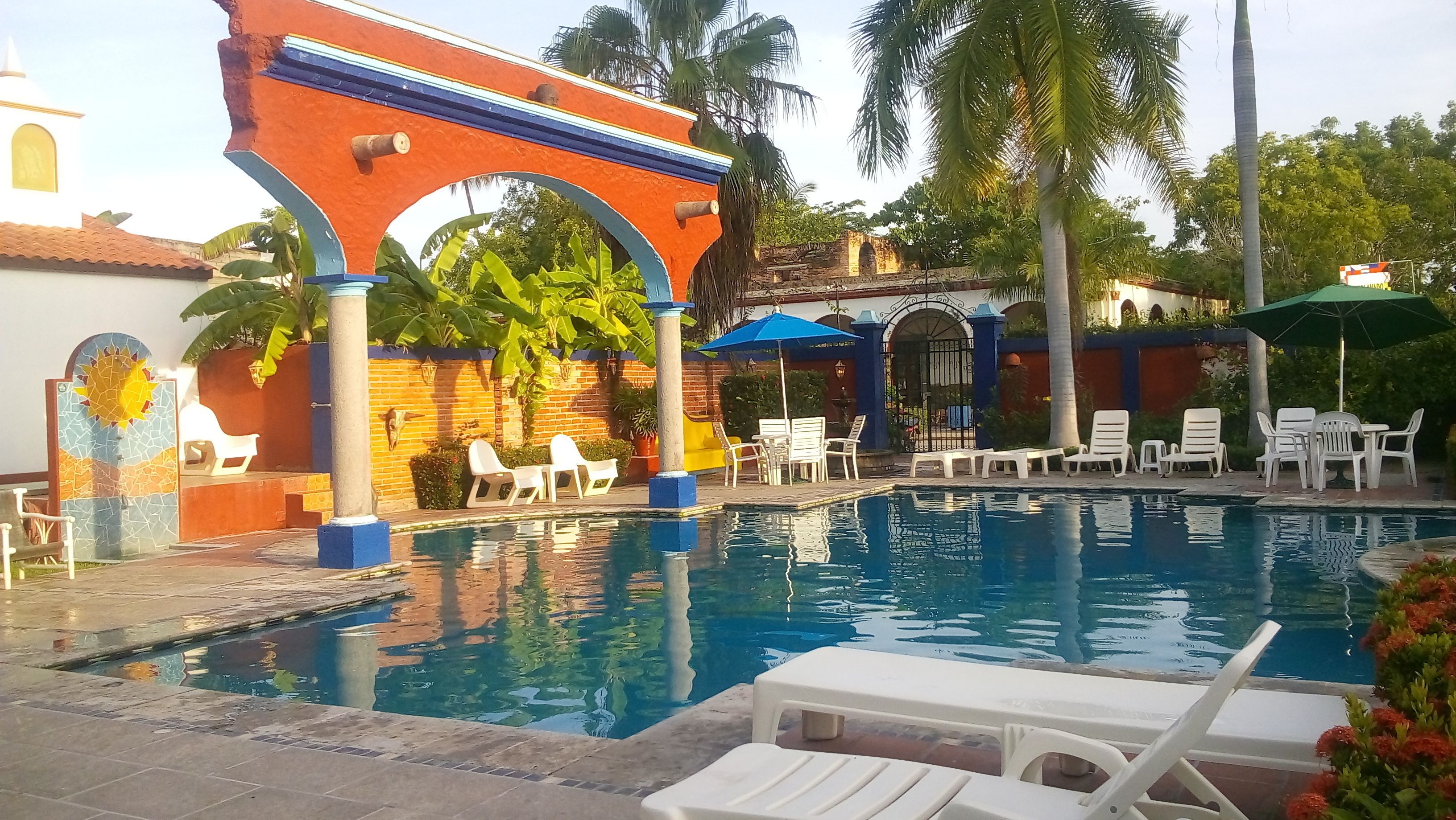 outdoor pool, open 8 am to 9 pm, pool umbrellas, pool loungers