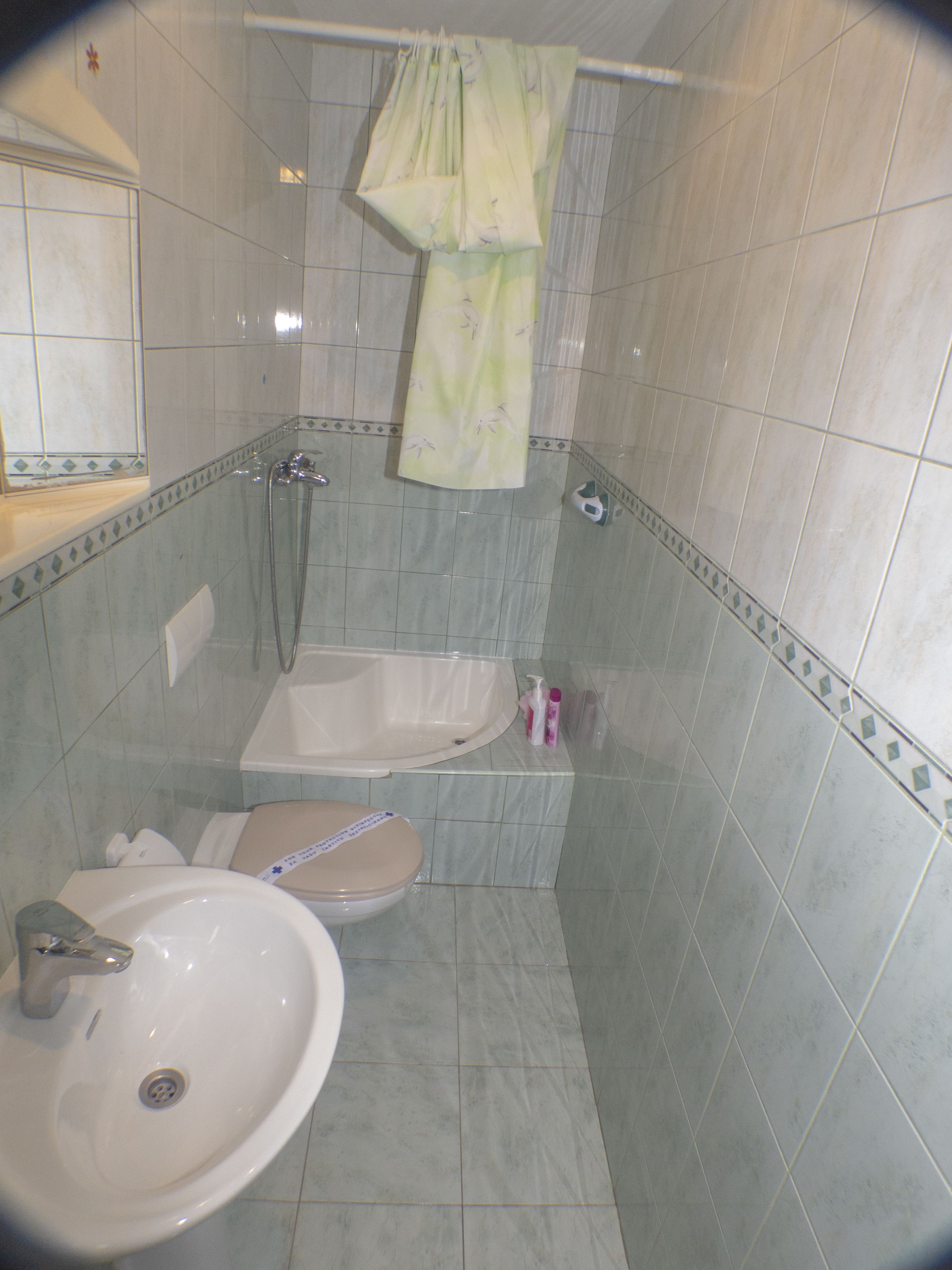 A bathroom with a bathtub, a toilet, and a sink.
