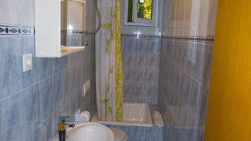 A bathroom with a sink, toilet, and bathtub.