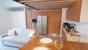 A modern kitchen with wooden cabinets, a built-in microwave, and a stainless steel refrigerator. - Design Central Apartment (Bergamo)