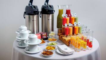 A breakfast buffet with various food items and beverages.