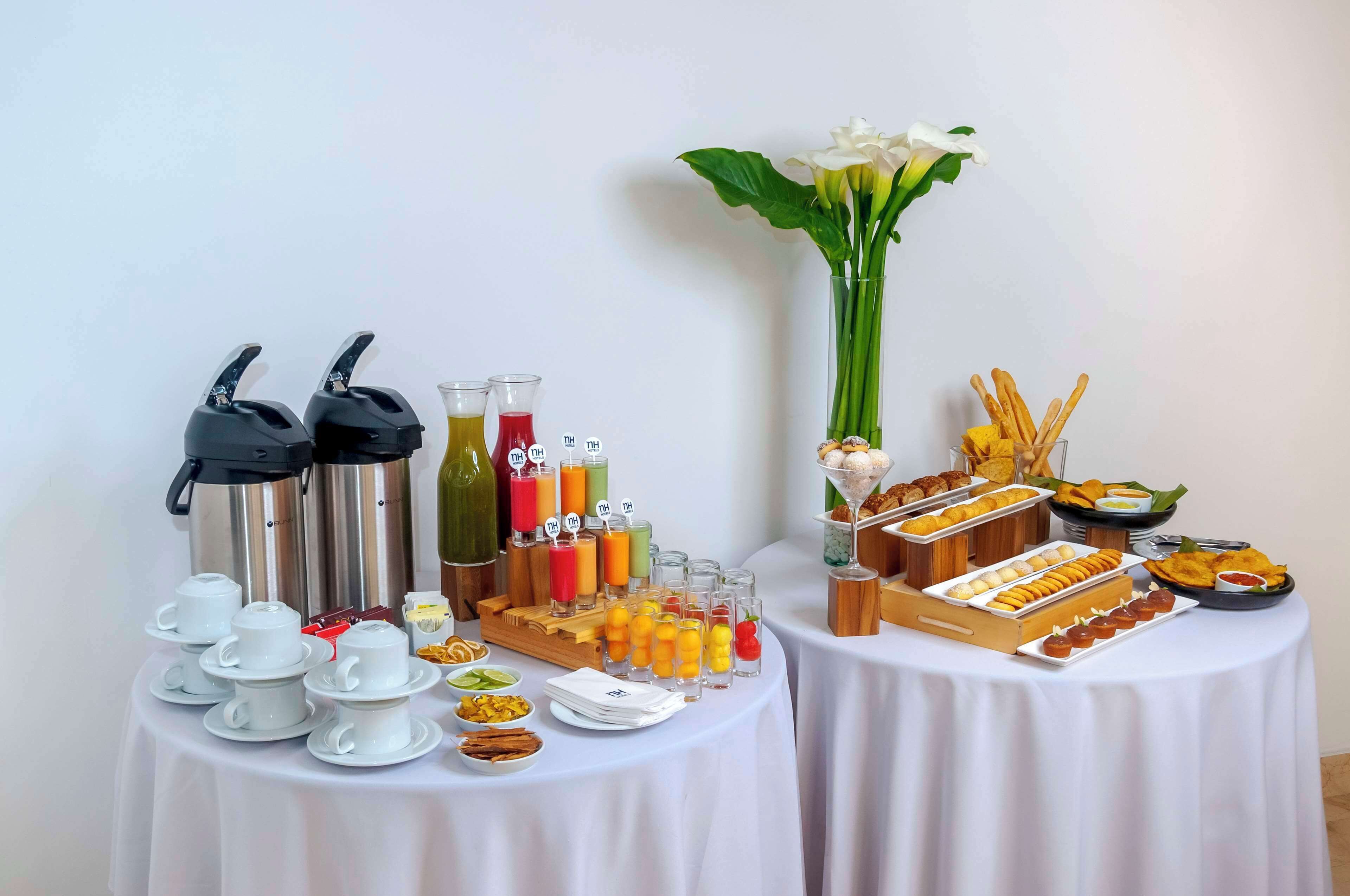 A buffet setup with coffee pots, juice dispensers, and a variety of food items on a table.