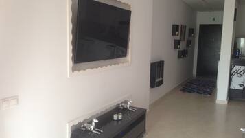 Apartment, 1 Bedroom | Living room | Flat-screen TV