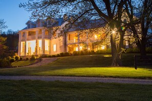 A large, two-story building with a symmetrical facade, multiple balconies, and a well-maintained lawn. - Weddings at Highholdborne (Bluemont)