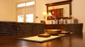 A dining table with a bowl and stacked books, a lamp, and a mirror above. - Situated in the CBD district with easy access to all Warrnambool has to offer (Warrnambool)