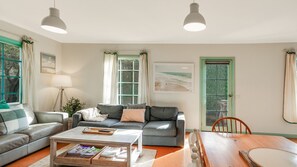 Relax in this inviting living space with a sofa, coffee table, and dining area.