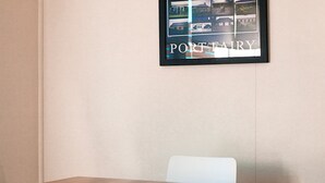 A framed picture of a building labeled "PORT FAIRY" on a wall. - Traditional historic cottage in a central location. (Port Fairy)