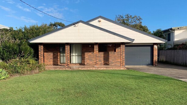 A single-story house with a brick facade, a garage, and a well-maintained lawn. - Lowset Pet Friendly Home (BONGAREE)
