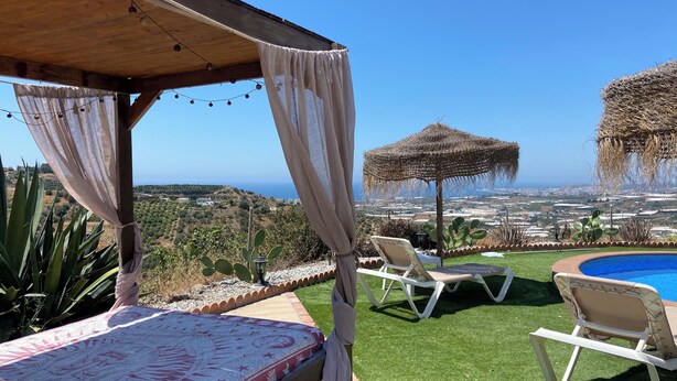 A covered outdoor area with a pool, lounge chairs, and a view of the landscape. - Beautiful rural house with swimming pool and sea views, special discounts (Algarrobo)