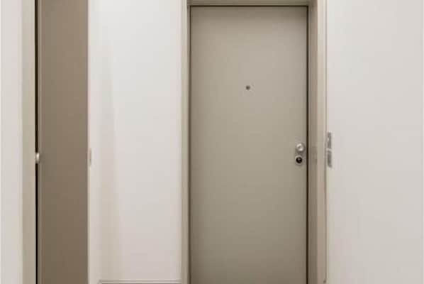 A closed door with a handle and a lock.