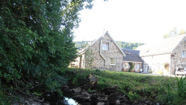 A stone building with a stone roof, a small stream, and lush greenery. - Escape to Rural Highlands Stunning Scenery, Sound of the Burn  Licence PK11943F (Aberfeldy)
