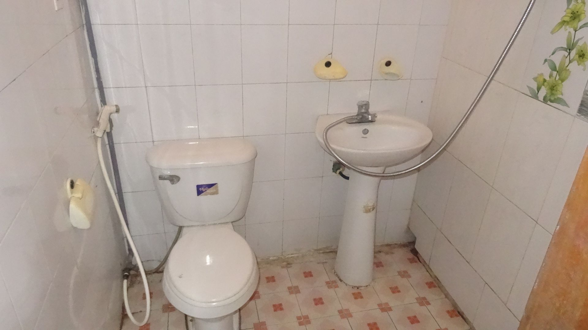 A small bathroom with a toilet and a sink.