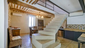 A spacious kitchen with a modern design, featuring a large island, a built-in oven, and a tiled backsplash. - Luxurious home in Vedène (Vedène)