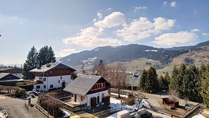 A building with a sloped roof, a small porch, and a snow-covered ground. - 1 RR6183 - (Megève)