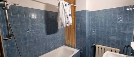 Ein Badezimmer mit Badewanne, Dusche und Waschbecken.