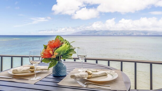 A table set for two with a view of the ocean.