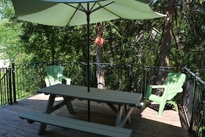 Back Deck with Weber Grill and outdoor dining furniture/umbrella/string lighting