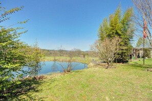 Surrounded by lush greenery and a tranquil body of water, this serene retreat offers a peaceful escape.