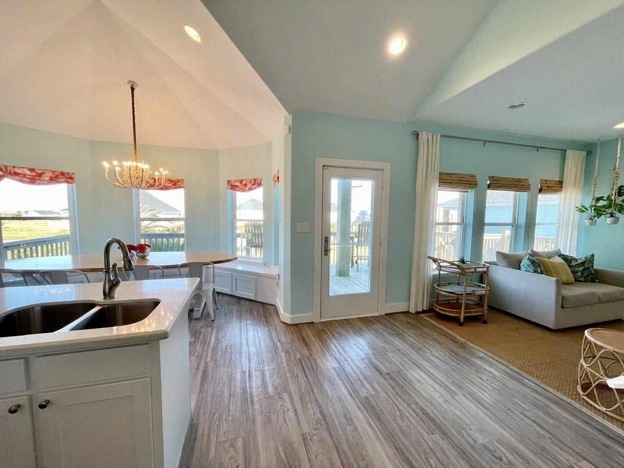 A spacious living area with a kitchen, a dining area, and a seating area with a view of the outdoors.