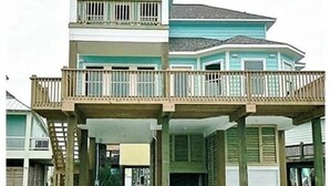 A two-story house with a balcony on the upper level.