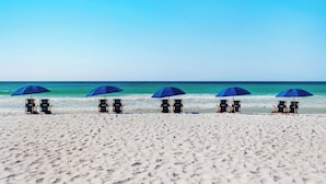 A beach with five rows of beach chairs and umbrellas, facing the ocean. - ☀️Palms 1616-Partial Gulf View🌴Beach Nearby-Lagoon Pool (Destin)