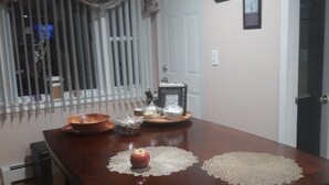 Una mesa de comedor con un mantel decorativo, un bol y un recipiente de vidrio.