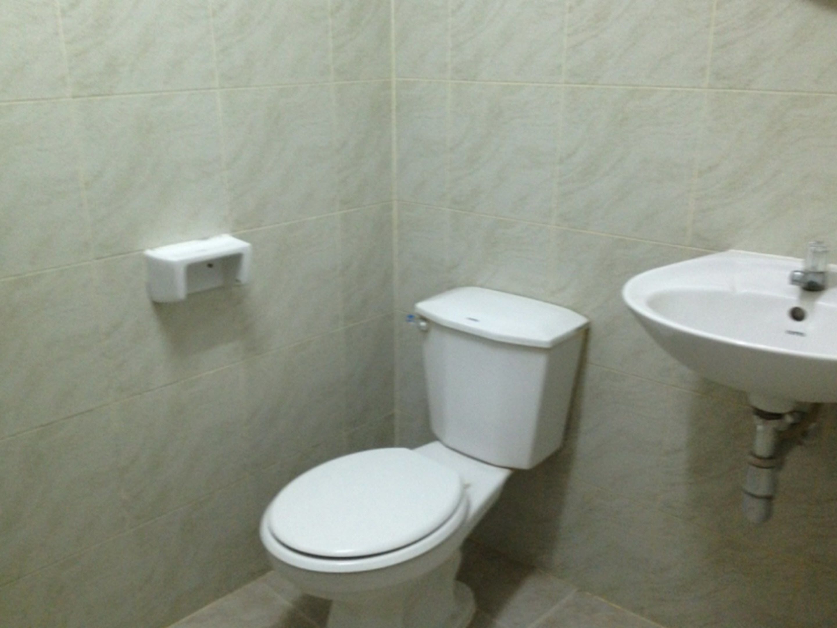 A small bathroom with a toilet and a sink.