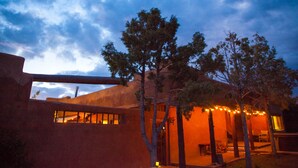 A building with a large overhang and a view of the sky. - Palace Of Miracles: Hot Tub, Lounge Spaces, +Casita, mtn views,5 courtyrds,6 FPs (El Prado)