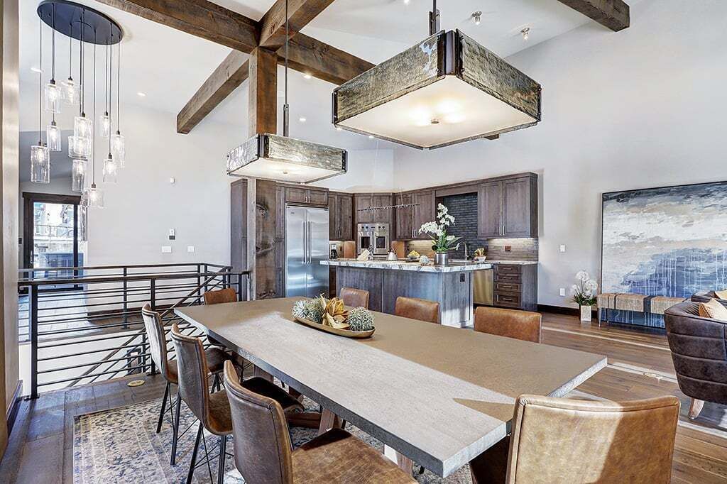 A modern kitchen with a central island, stainless steel appliances, and pendant lighting.