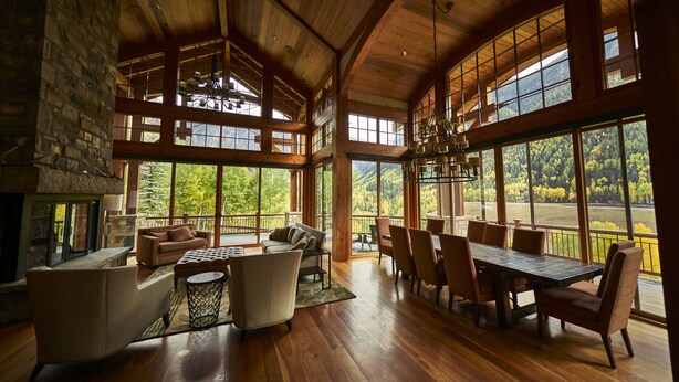 A spacious room with a large dining table, comfortable seating, and large windows offering scenic views. - Family, Friends and Festivals! Enjoy Telluride at its Finest! (Telluride)